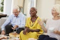 Group Of Senior Friends Enjoying Afternoon Tea At Home Together Royalty Free Stock Photo