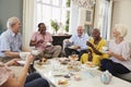 Group Of Senior Friends Enjoying Afternoon Tea At Home Together Royalty Free Stock Photo