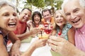 Group Of Senior Friends Enjoying Cocktails In Bar Together Royalty Free Stock Photo