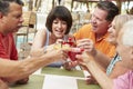 Group Of Senior Friends Enjoying Cocktails In Bar Together Royalty Free Stock Photo