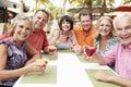 Group Of Senior Friends Enjoying Cocktails In Bar Together Royalty Free Stock Photo