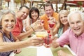 Group Of Senior Friends Enjoying Cocktails In Bar Together Royalty Free Stock Photo