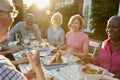 Group Of Senior Friends Enjoying Outdoor Dinner Party At Home Royalty Free Stock Photo