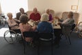 Group of senior friends having breakfast on dining table at nursing home Royalty Free Stock Photo