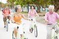 Group Of Senior Friends Having Fun On Bicycle Ride Royalty Free Stock Photo