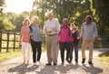 Group Of Senior Friends Hiking In Countryside