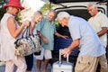 Group Of Senior Friends Loading Luggage Into Trunk Of Car About To Leave For Vacation Royalty Free Stock Photo