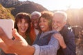 Group Of Senior Friends Posing For Selfie As They Hike Along Trail In Countryside Together