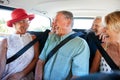 Group Of Senior Friends Sitting In Back Of Van Being Driven To Vacation Royalty Free Stock Photo