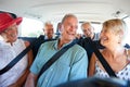 Group Of Senior Friends Sitting In Back Of Van Being Driven To Vacation Royalty Free Stock Photo