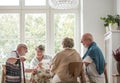 Group of senior sitting together at nursing home dining room