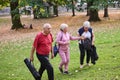 A group of senior friends takes a well-deserved break in nature, fostering not only fitness but also camaraderie and a Royalty Free Stock Photo