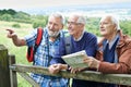 Group Of Senior Male Friends Hiking In Countryside