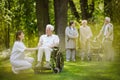 Senior patients with caregiver in the garden of nursing home Royalty Free Stock Photo