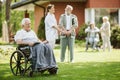 Senior patients with caregiver in the garden of nursing home Royalty Free Stock Photo