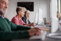 Group of senior people attending computer and technology education class. Royalty Free Stock Photo