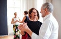 Group of senior people in dancing class with dance teacher. Royalty Free Stock Photo