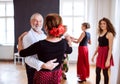 Group of senior people in dancing class with dance teacher. Royalty Free Stock Photo