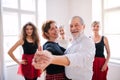 Group of senior people in dancing class with dance teacher. Royalty Free Stock Photo