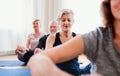 Group of senior people doing yoga exercise in community center club. Royalty Free Stock Photo