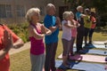 Group of senior people performing yoga in the park Royalty Free Stock Photo