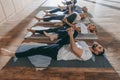 group of senior people stretching in yoga mats