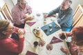 Group of senior people toasting italian style moka coffee after lunch - Mature happy friends eating biscuits and laughing together