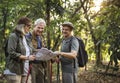 Group of senior trekkers checking a map for direction Royalty Free Stock Photo