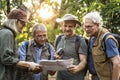 Group of senior trekkers checking a map for direction Royalty Free Stock Photo