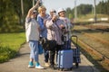 Group of senior women take a self-portrait on a platform waiting for train to travel during a COVID-19 pandemic