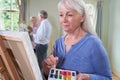 Group Of Seniors Attending Painting Class With Teacher Royalty Free Stock Photo