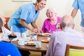 Group of seniors having food in nursing home Royalty Free Stock Photo