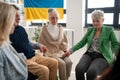 Group of seniors holding hands and praying for Ukraine together in church community center. Royalty Free Stock Photo