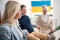 Group of seniors holding hands and praying for Ukraine together in church community center. Royalty Free Stock Photo