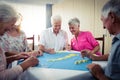 Group of seniors playing dominoes Royalty Free Stock Photo