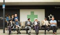 Group of seniors sitting on park bench talking and smiling