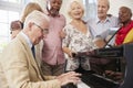 Group Of Seniors Standing By Piano And Singing Together Royalty Free Stock Photo