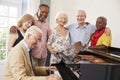 Group Of Seniors Standing By Piano And Singing Together Royalty Free Stock Photo