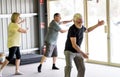 Group of elderly senior people practicing Tai chi class in age care gym facilities Royalty Free Stock Photo