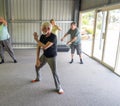 Group of elderly senior people practicing Tai chi class in age care gym facilities Royalty Free Stock Photo