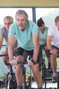 Group of seniors using spinning bikes