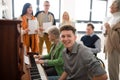 Group of seniors with young teacher singing together at choir rehearsal. Royalty Free Stock Photo