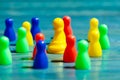 Group, set of colorful game pieces, shallow dof, closeup. Large variation of game pieces, different colors. One chess pawn