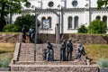 A group of seven bronze sculptures AFTER WORSHIP on the steps at the church, Saldus, Latvia