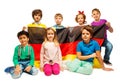 Group of seven children sitting with a German flag