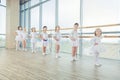 Group of seven little ballerinas standing in row and practicing Royalty Free Stock Photo