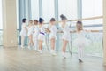 Group of seven little ballerinas standing in row and practicing Royalty Free Stock Photo