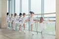 Group of seven little ballerinas standing in row and practicing Royalty Free Stock Photo