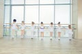 Group of seven little ballerinas standing in row and practicing Royalty Free Stock Photo