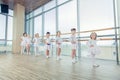 Group of seven little ballerinas standing in row and practicing Royalty Free Stock Photo